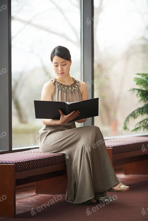Preview: Picking the perfect passage. Shot of an elegantly dressed young woman reading through a folder.