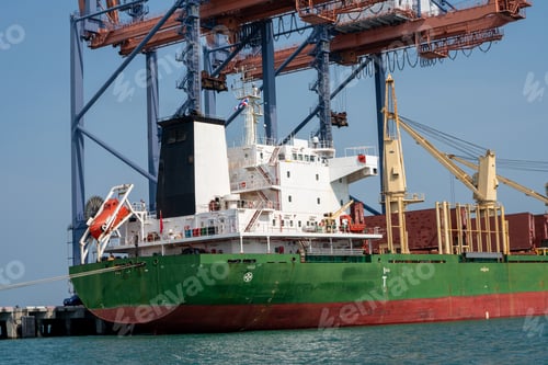 Preview: crane loading cargo container from truck to container ship in the international terminal logist