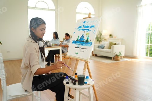 Preview: Young artist creating a colorful landscape painting in a bright studio