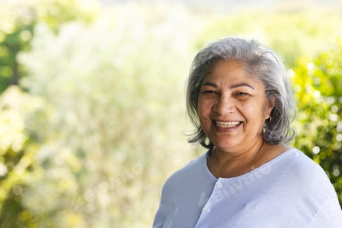 Preview: Portrait of happy biracial senior woman laughing in sunny garden, copy space