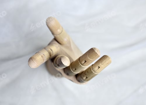 Preview: Top view of a wooden mannequin hand on a white background