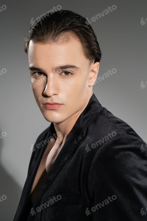 Preview: portrait of young and stylish man with confident face expression and brunette hair looking at