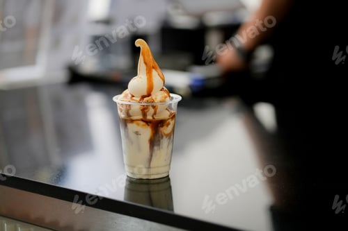 Preview: Glass of ice latte coffee with scoop of vanilla ice cream and on black table at coffee shop.