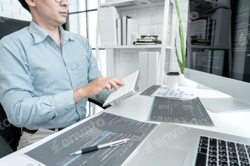 Preview: Male programmer is programming to develop program app and website of corporate while working