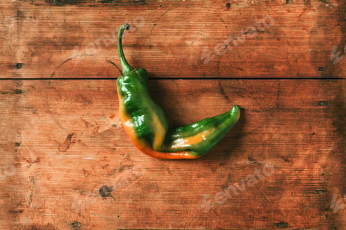 Preview: Ugly bell pepper on wooden background. Concept of zero waste production. Top view. Copy space. Non