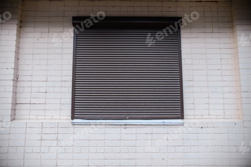 Preview: Window shutters on the building. Closed shop. Lockdown, bankruptcy, street riots concept