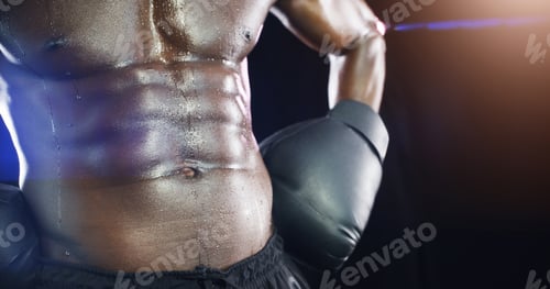 Preview: Studio shot of an unrecognizable shirtless sportsman posing against a dark background
