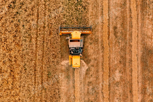 Preview: Aerial view of the combine harvester agriculture machine working on ripe wheat field.