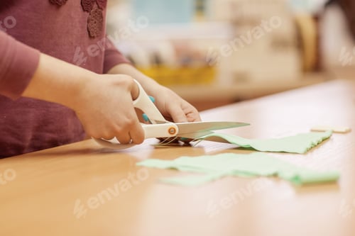 Preview: Workplace seamstress. Dressmaker cuts fabric for sewing dresses.