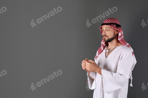 Preview: Muslim man praying on gray background. Space for text
