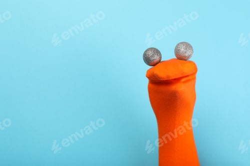 Preview: Sock puppet with baubles on blue background