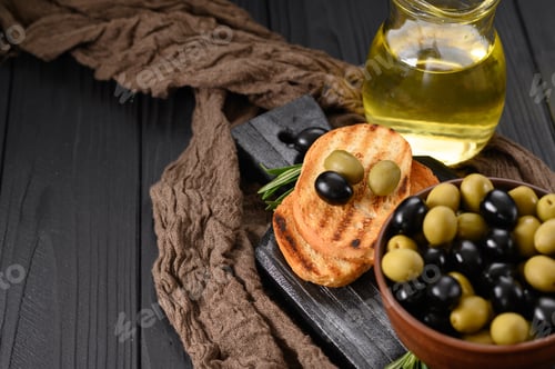 Preview: Black and green olives on a dark wooden black background.