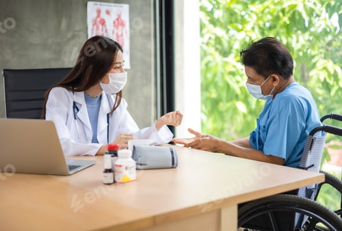 Preview: Attentive Woman Doctor Speaking to Patient in Wheelchair