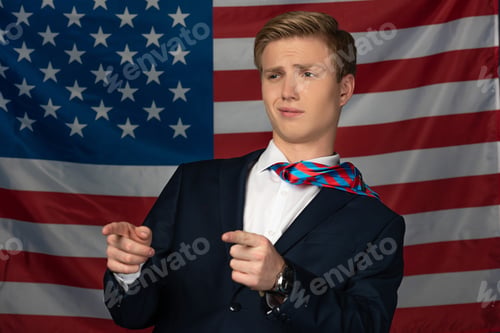 Preview: man pointing with fingers away on american flag background