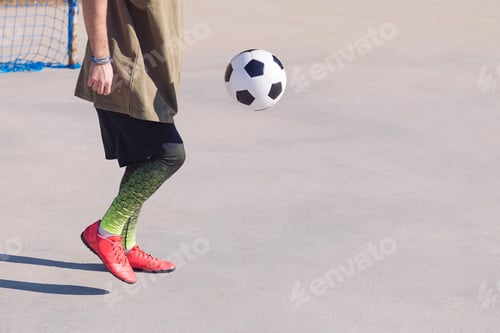 Preview: unrecognizable football player playing the ball