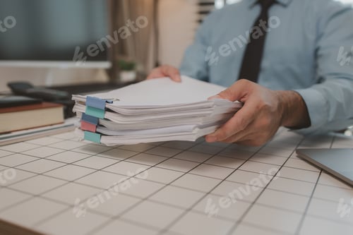 Preview: a businessman is handling documents in the office, an accountant is collecting documents