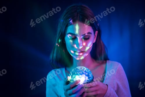 Preview: A young brunette Caucasian woman in a white t-shirt in a noghtclub