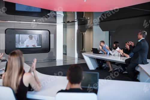 Preview: Business people applauding international customers in video conference