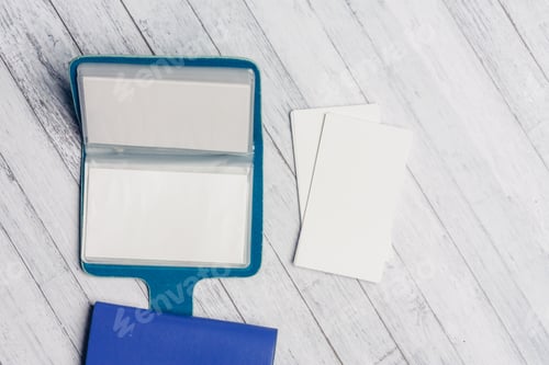 Preview: business card holder with letterheads on a wooden table top view Copy Space