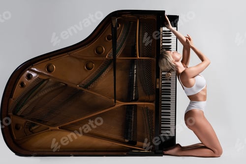 Preview: Sensual Young Woman in White Lingerie Posing by Side-Flipped Grand Piano in Studio