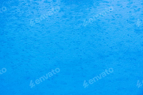 Preview: Image to use as background of rain falling on the water of a lake of transparent blue