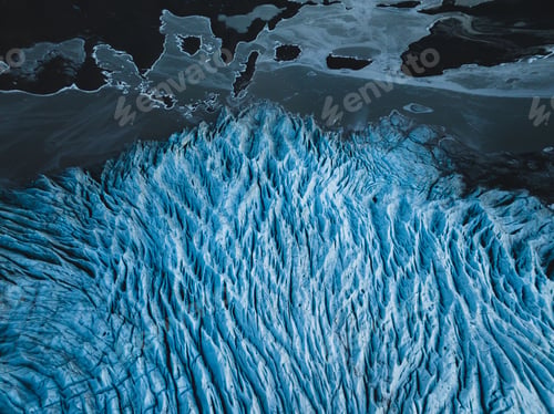 Preview: Aerial view of a glacier with intricate blue ice patterns.