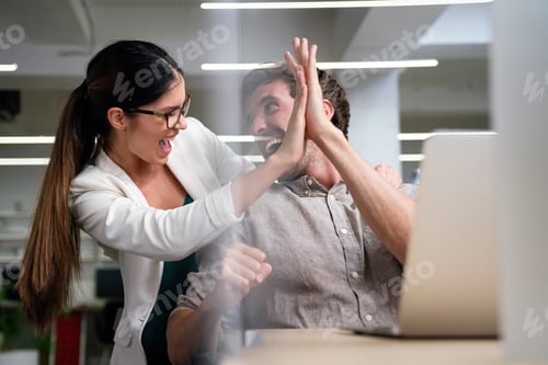 Preview: Successful Colleagues Celebrating with High Five in Office
