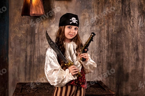 Preview: Smiling little girl actress 7-8 year old in pirate's image with gun and saber at gray