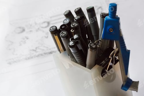 Preview: High angle view of a selection of fineliners in a pencil pot.