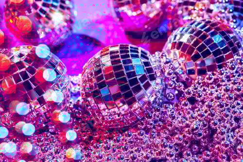Preview: Shiny small disco balls sparkling in a beautiful purple light. Disco party concept