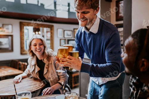 Preview: Man getting drinks for friends at a pub