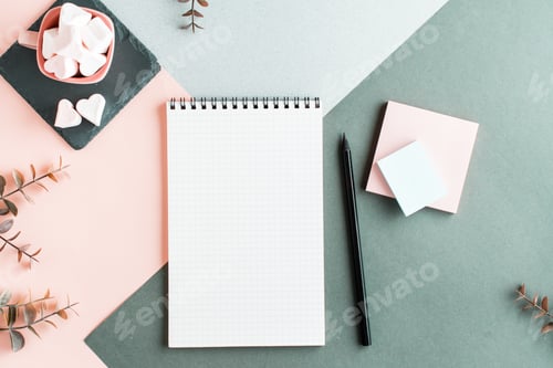 Preview: Blank notepad, pencil, writing paper and marshmallows in a cup on a colored background. Top view
