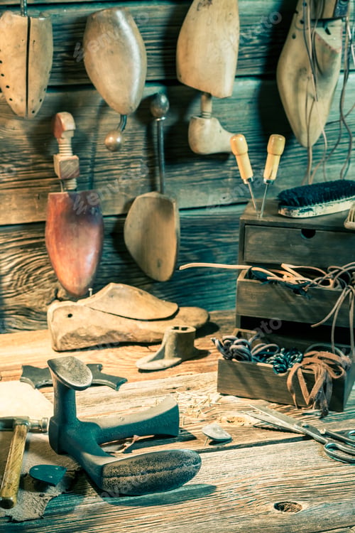 Preview: Shoemaker workplace with tools, leather and shoes to repair
