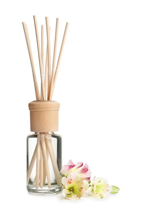 Preview: New reed air freshener and flowers on white background