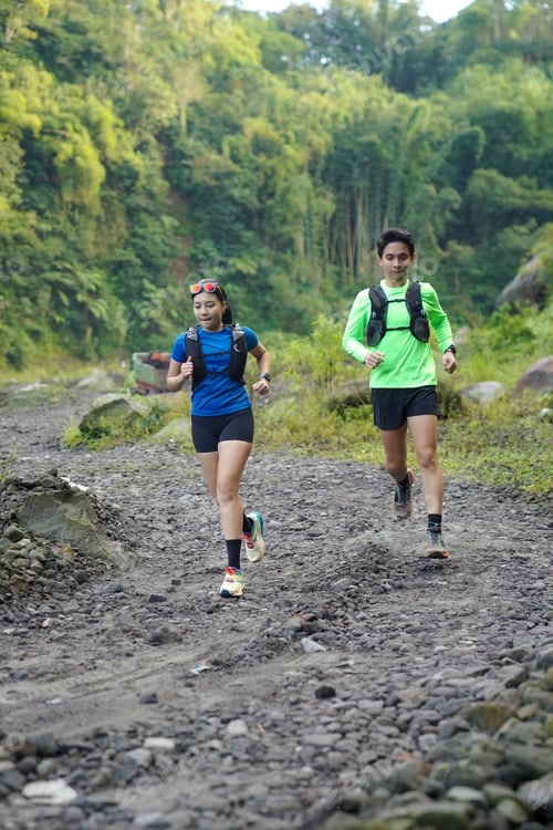 Preview: Asian Indonesian couple trail running outdoors, active sustainable lifestyle exercise