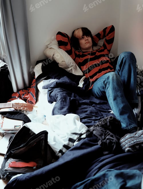 Preview: Teenage boy relaxing on bed