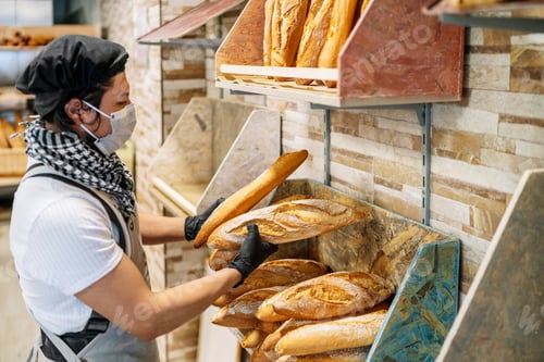 Preview: Latino baker shelving freshly baked bread