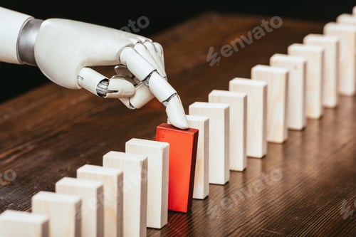 Preview: robotic hand picking red wooden brick from row of blocks on desk