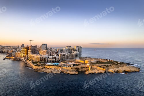 Preview: Aerial view of Sliema in Malta, skyline at sunset, blue sea waters and sky. Aerial drone view