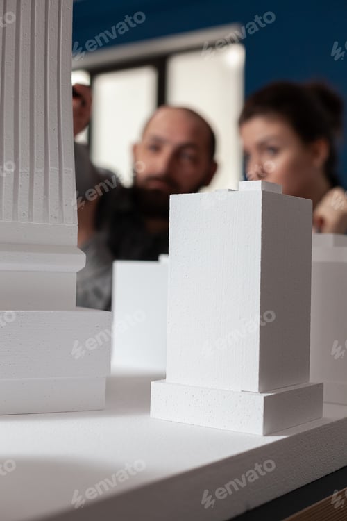 Preview: Talking architect team sitting at desk in professional office