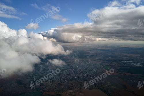 Preview: Aerial view from airplane window at high altitude of distant city