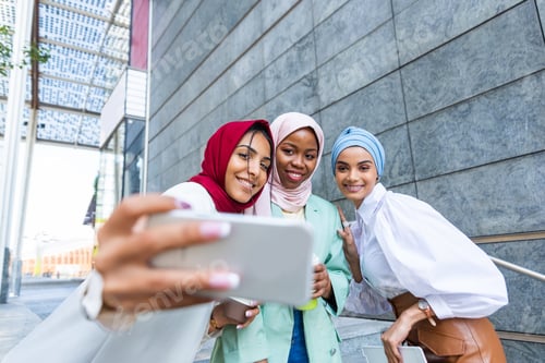 Preview: Beautiful muslim girl wearing hijab bonding outdoors
