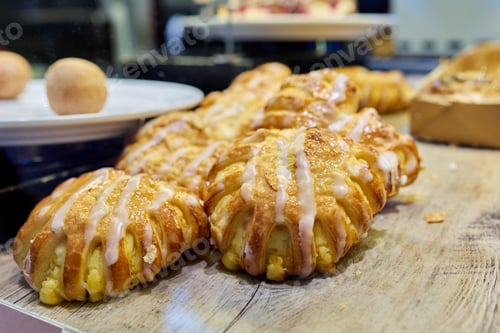 Preview: Close-up of bakery pastry shop display with fresh sweet buns with cream
