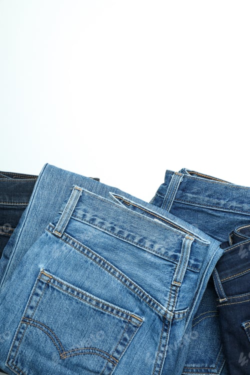 Preview: Ukraine, Kyiv, 08.10.2023 Folded jeans on a white background