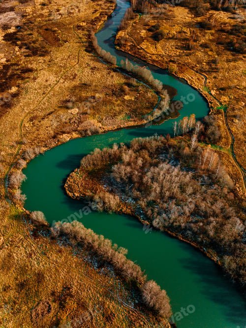 Preview: Aerial view of turquoise winding river and golden autumn