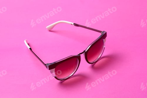 Stylish Sunglasses on a Bright Pink Background