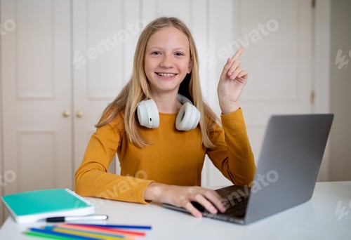 Preview: Smiling Teenage Girl Engaging in Online Learning at Home