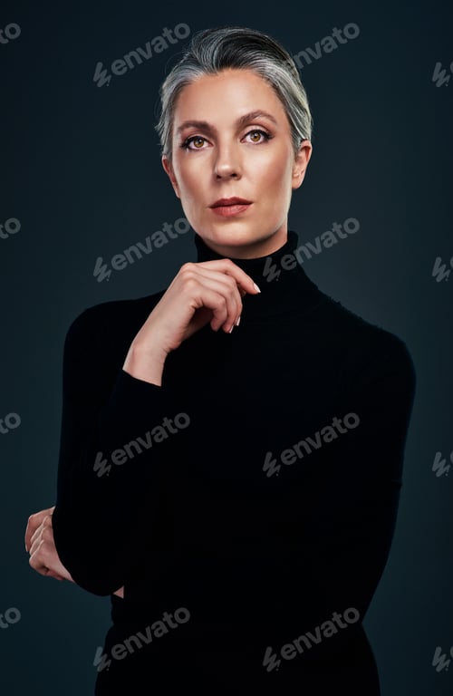 Preview: Studio portrait of a beautiful mature woman posing against a dark background
