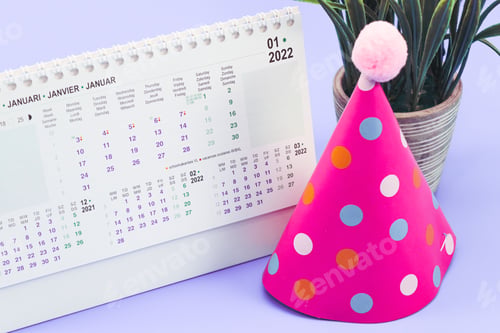 Preview: Hat paper cone, desktop paper calendar for January 2022 with a flower in a pot on a light lilac.