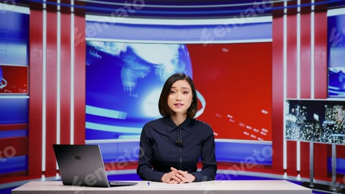 Preview: Asian presenter hosting news segment